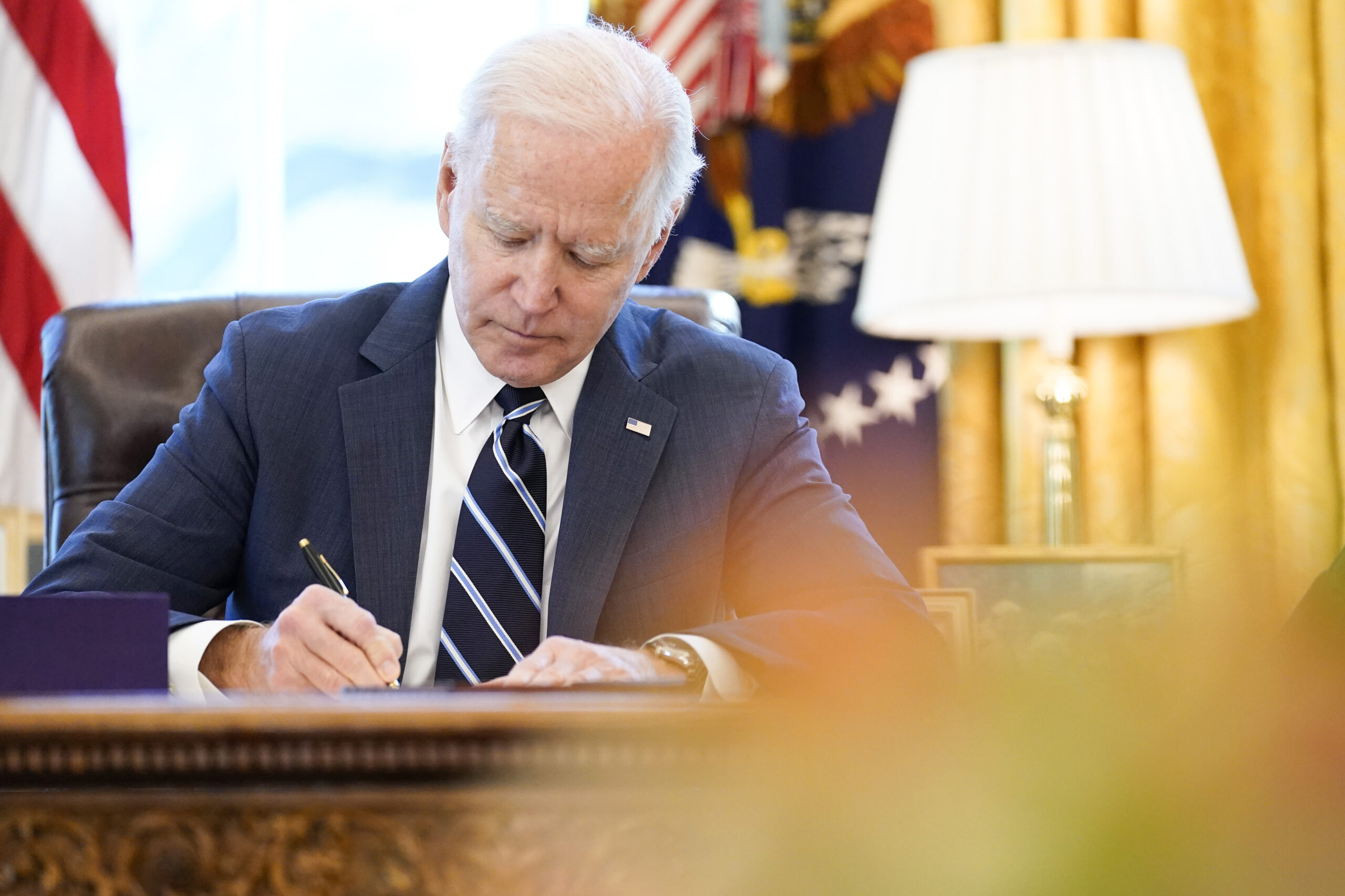 FILE - President Joe Biden signs the American Rescue Plan, a coronavirus relief package, in the Ova...