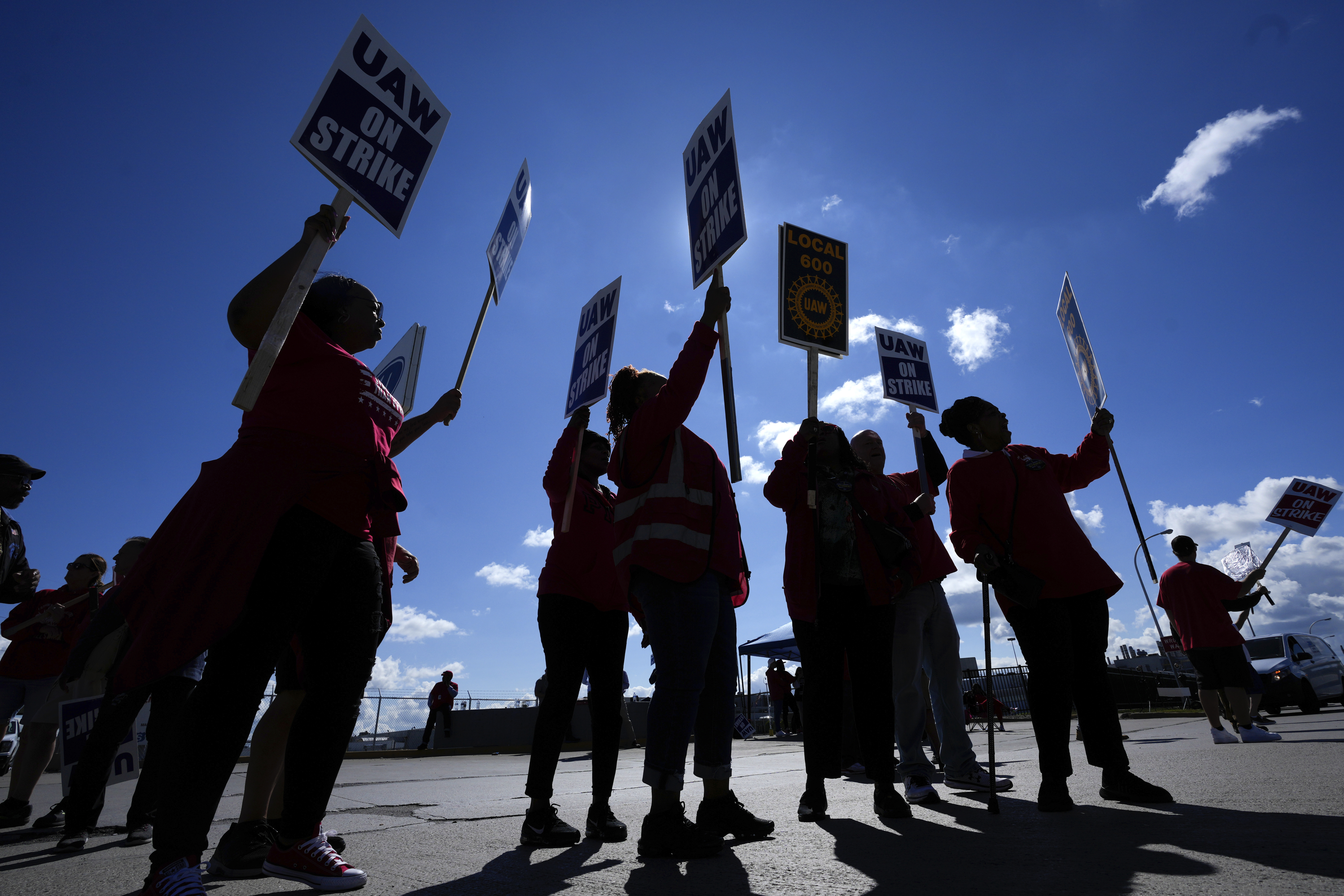 FILE - United Auto Workers members walk the picket line at the Ford Michigan Assembly Plant in Wayn...