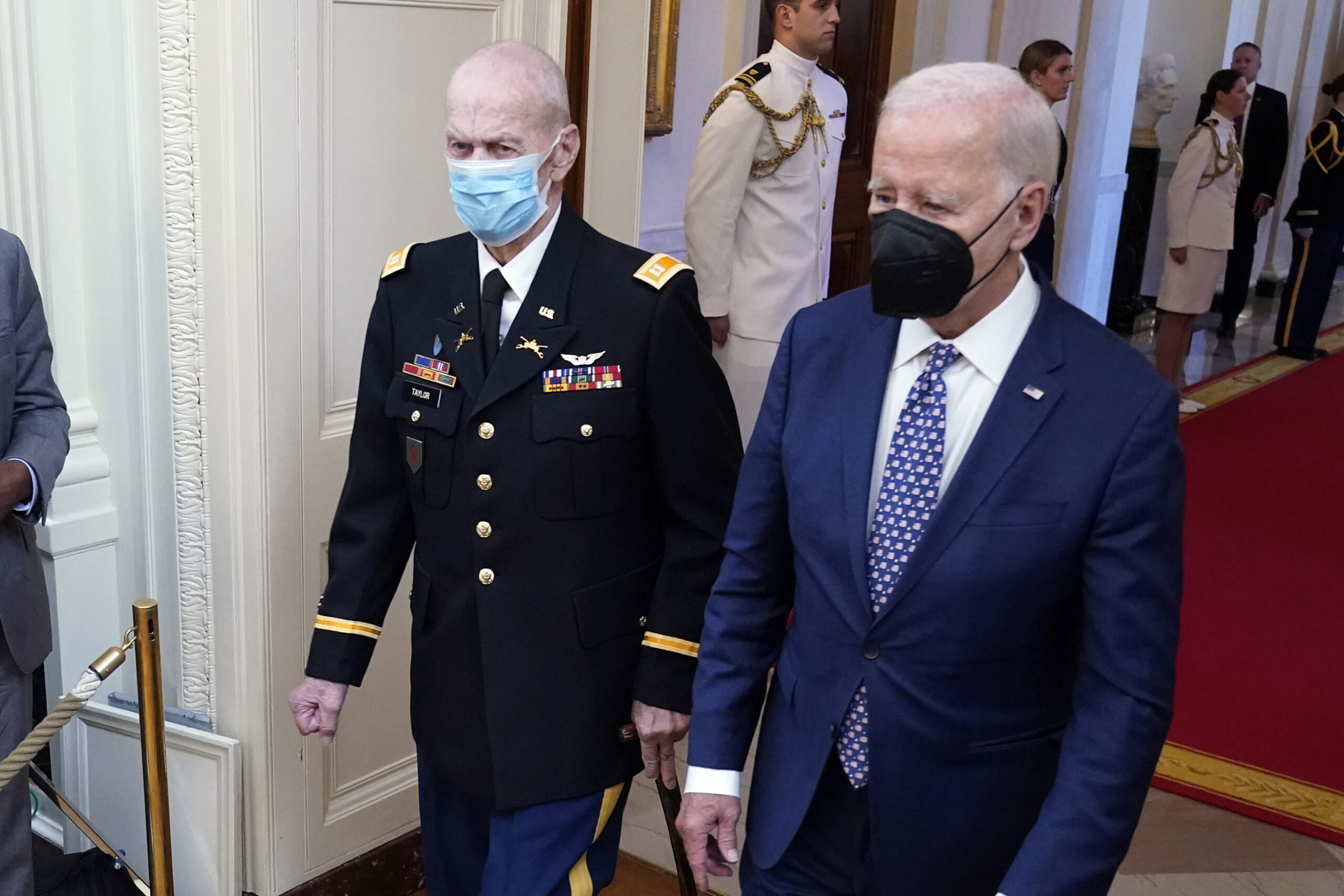 President Joe Biden arrives with Capt. Larry Taylor, an Army pilot from the Vietnam War who risked ...