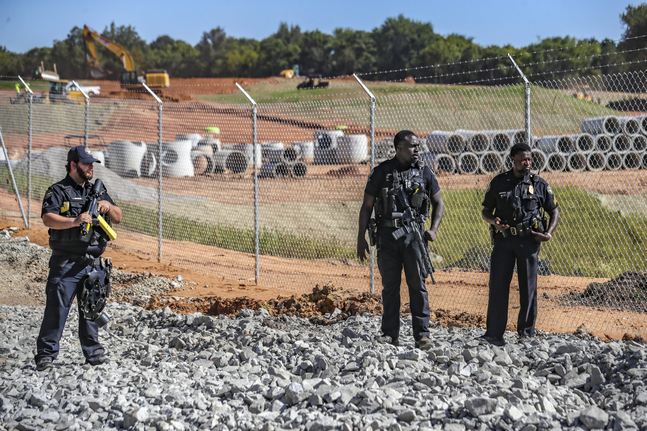 Law enforcement personnel stand at the site of Atlanta's proposed public safety training center, Th...