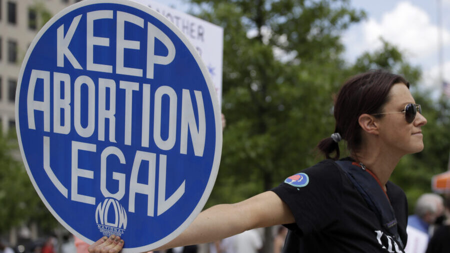 FILE - An. Abortion rights demonstrator holds a sign during a rally on May 14, 2022, in Chattanooga...