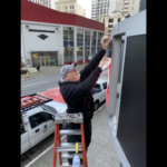 Workers take down sign of the last Bartell Drugs in downtown Seattle