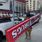 Workers take down sign of the last Bartell Drugs in downtown Seattle