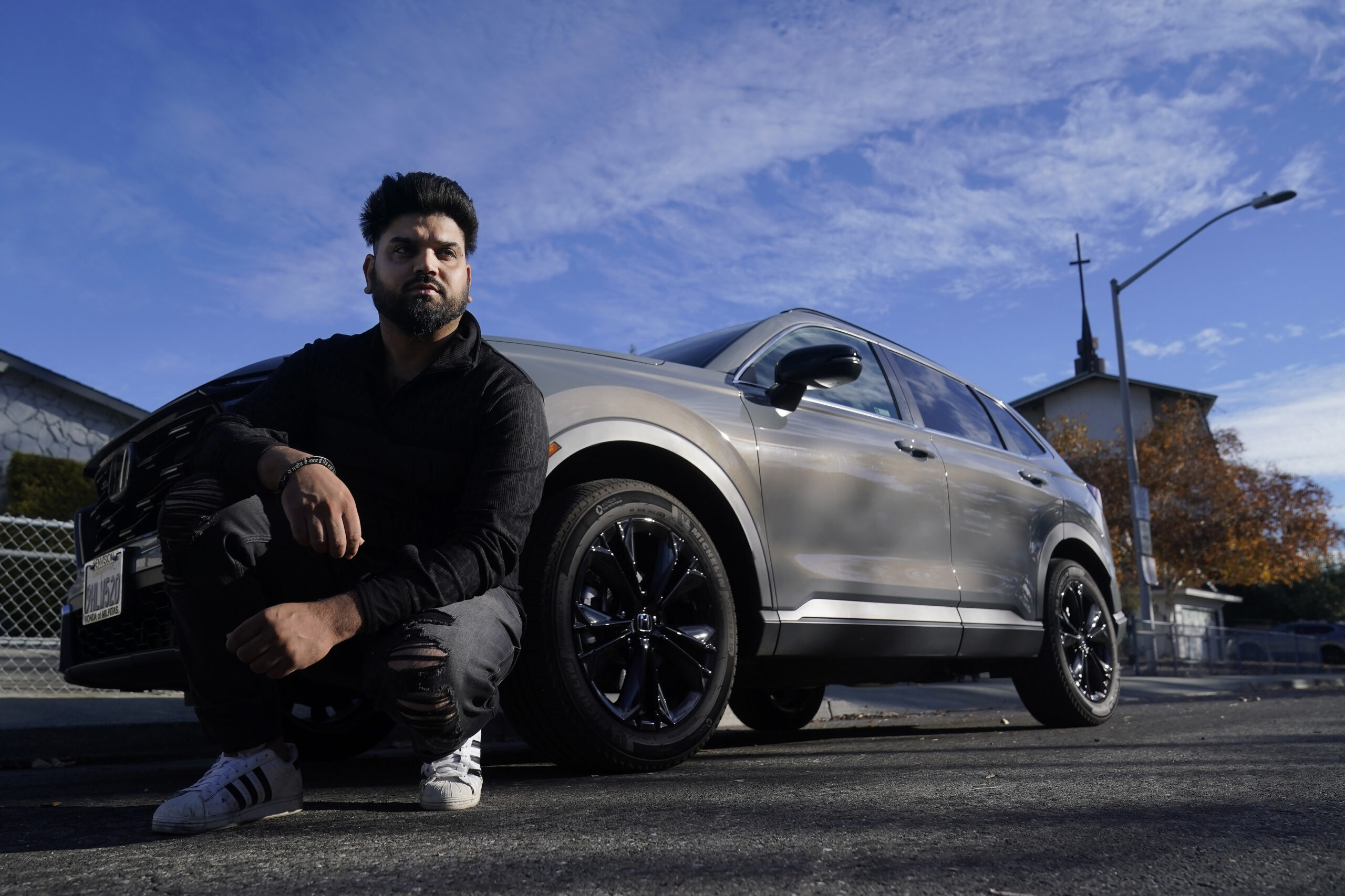 Shalinder Singh poses for photos in front of a 2024 Honda CR-V Hybrid in Sunnyvale, Calif., Monday,...