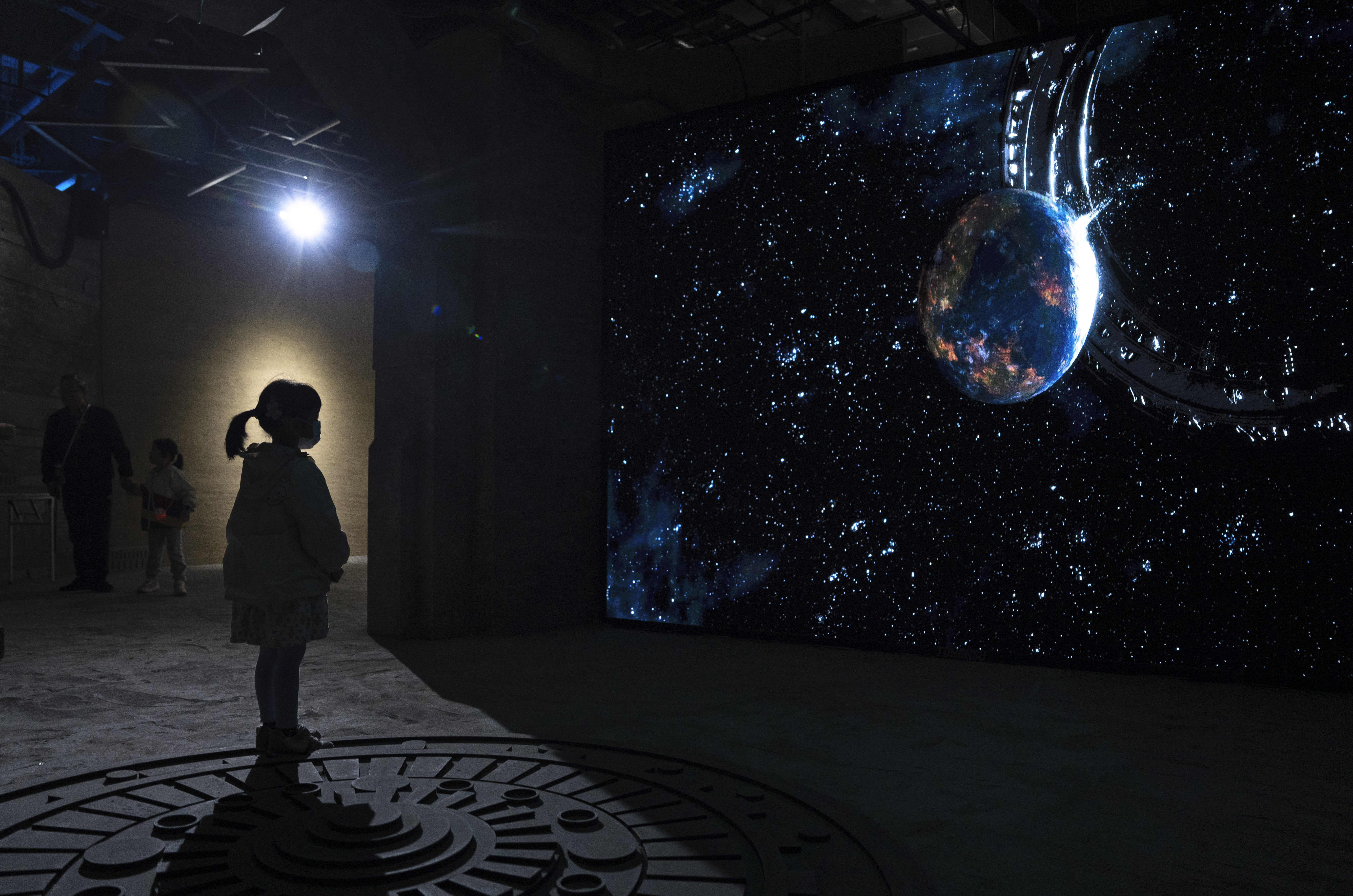 A child watches a video depicting the science fiction universe from a trilogy by Chinese author Liu...
