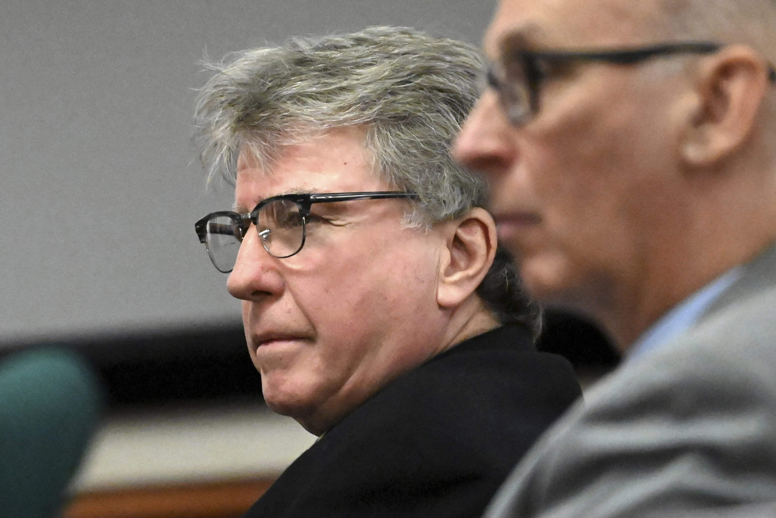 FILE - Defendant Kevin Monahan, left, listens to opening statements in his murder trial, Jan. 11, 2...