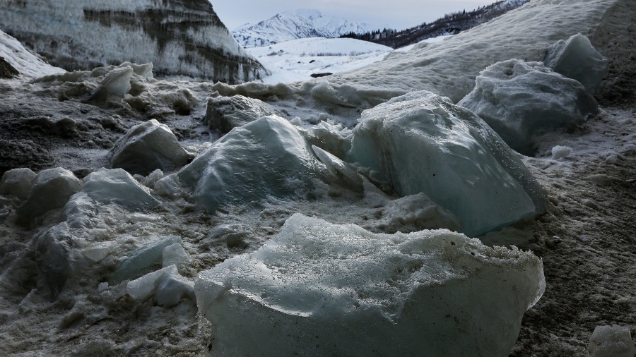 Image: Fallen ice melts in an ice cave created by meltwater at the retreating Castner Glacier in th...