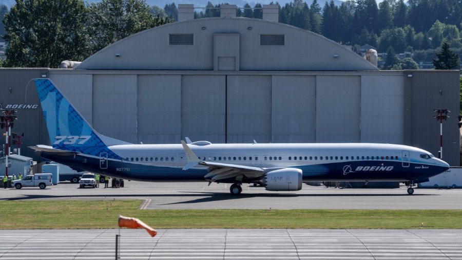 Image: A Boeing 737 Max 10 airliner taxis past a hanger on the flight line before its first flight ...