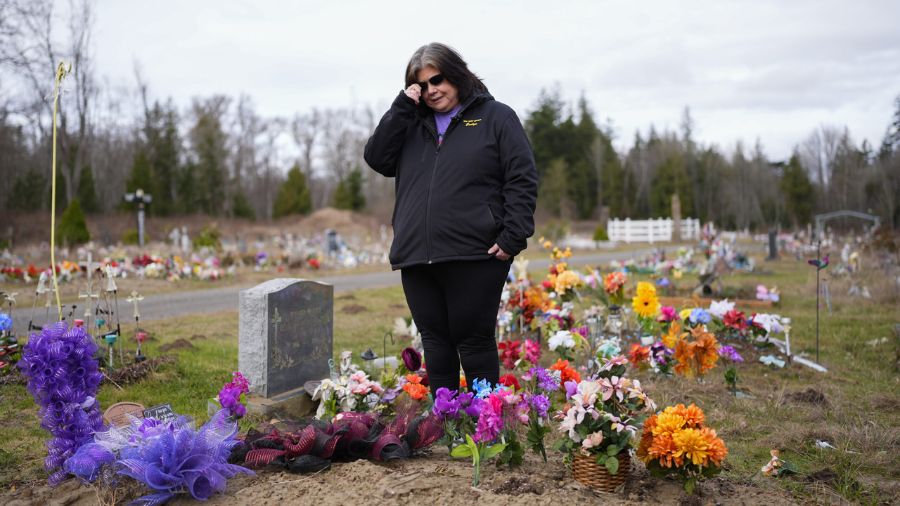 Photo: Evelyn Jefferson, a crisis outreach supervisor for Lummi Nation, stands at the grave of her ...