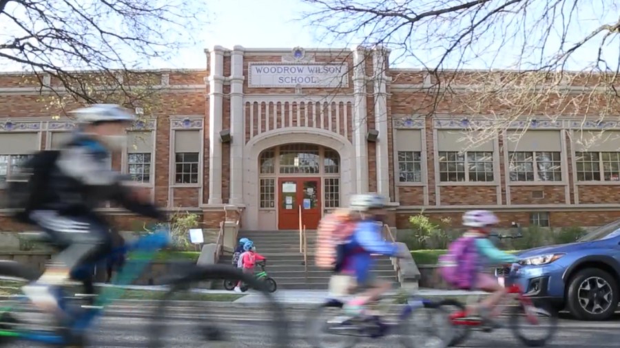 Image: Children bike past Wilson Elementary in Spokane....