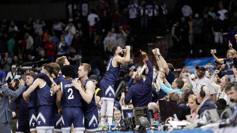Photo: Yale players, including guard Yassine Gharram, center, celebrate with fans after their 78-76...