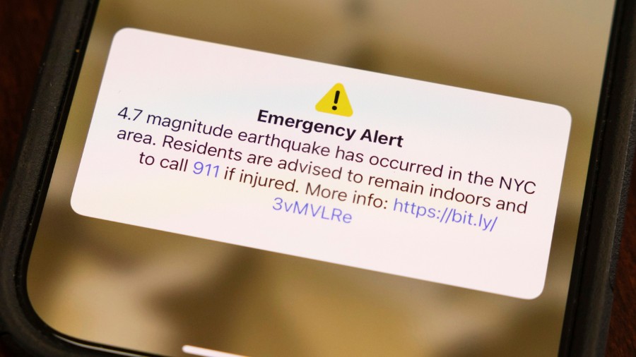 Image: A screen shows an emergency alert in New York City area for an earthquake on Friday, April. ...