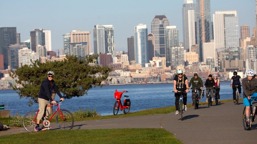 Photo: Seattlites bike past Alki beach....