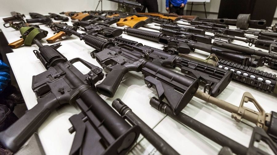 Photo: In this Dec. 27, 2012, file photo, a variety of military-style semi-automatic rifles obtaine...