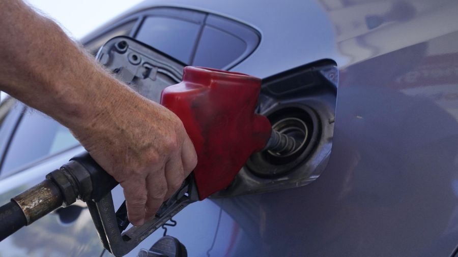 Photo: A customer pumps gas at an Exxon gas station, Tuesday, May 10, 2022....