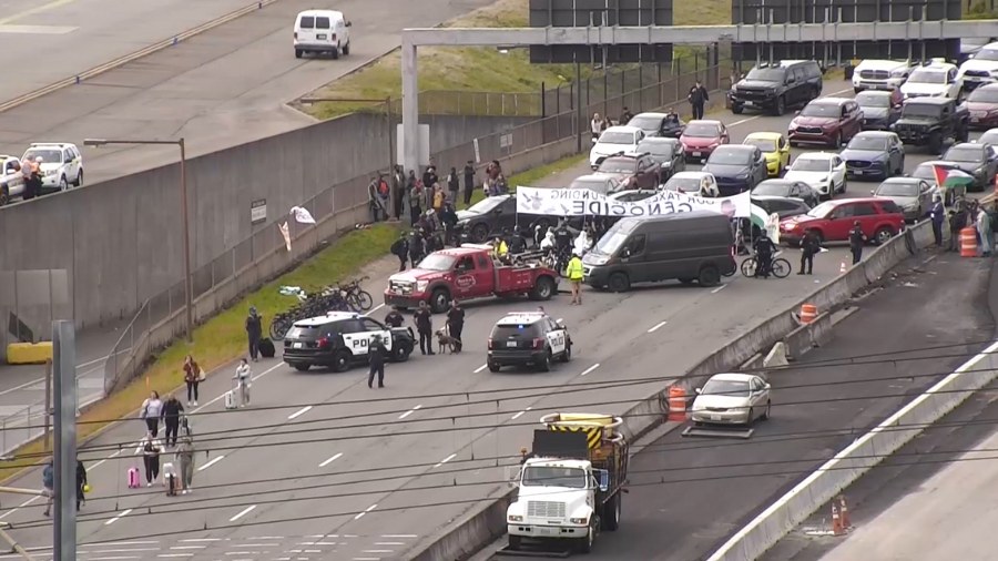 Image: A tow truck removes one of the cars blocking the expressway leading to Seattle-Tacoma Intern...