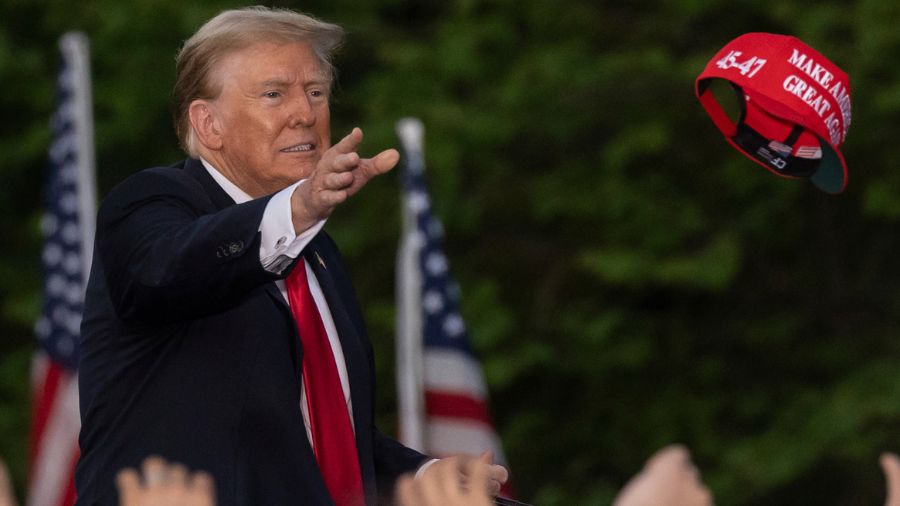 Photo: Republican presidential candidate former President Donald Trump throws a "MAGA" hat during a...