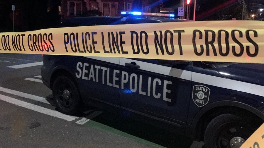 Image: A Seattle Police Department vehicle can be seen parked near some yellow police tape....