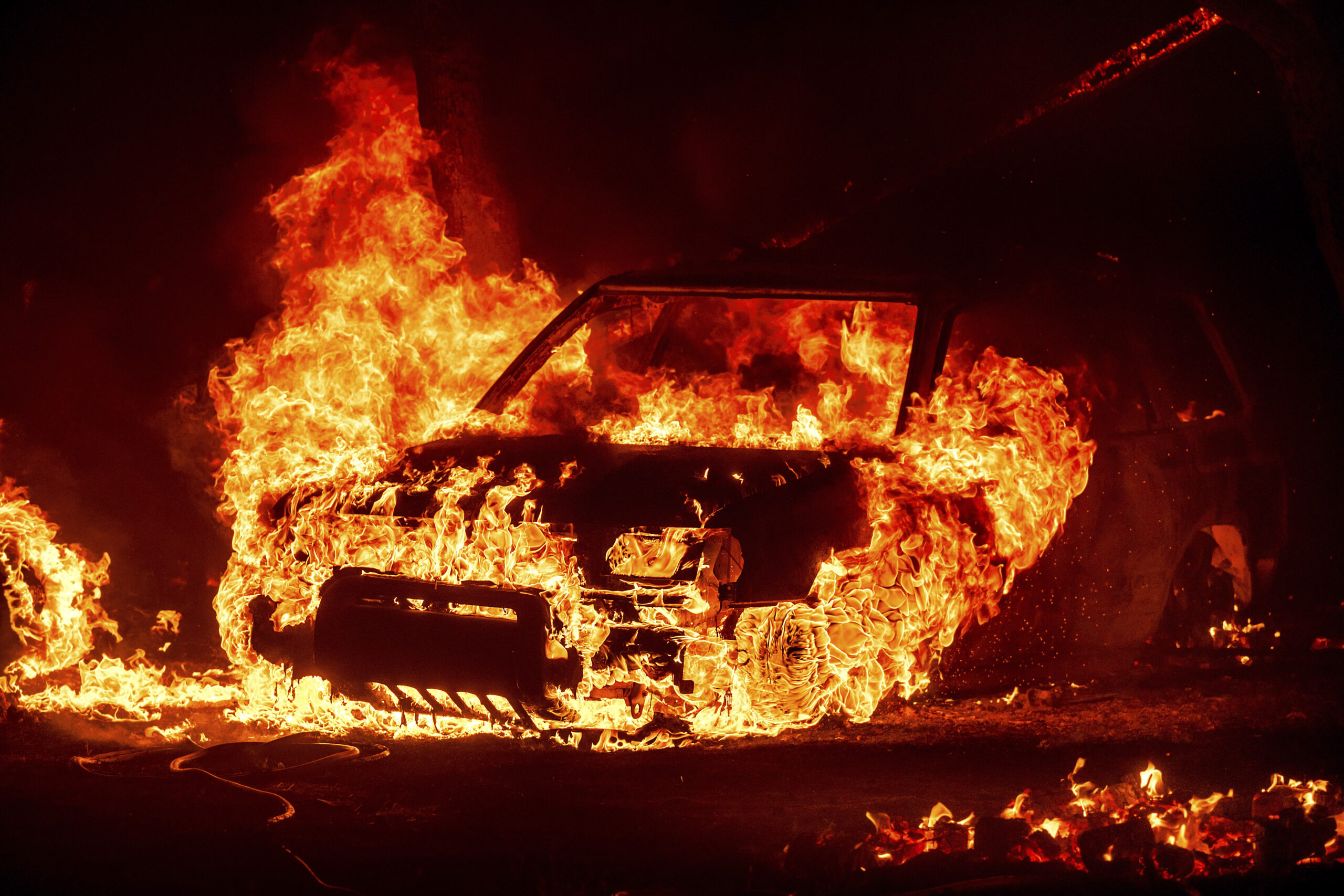 Flames consume a vehicle as the Park Fire jburns in Tehama County, Calif., on Friday, July 26, 2024...
