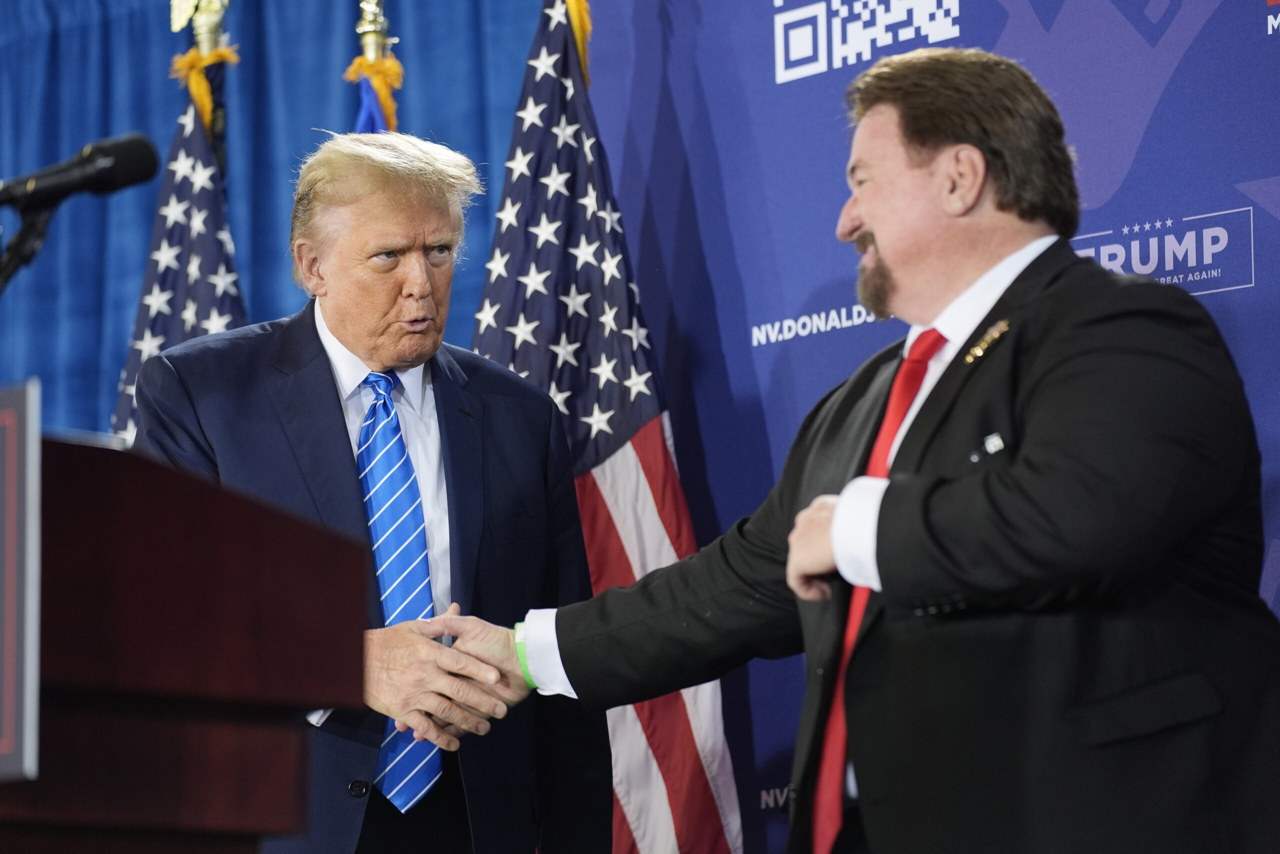 FILE - Nevada GOP chair Michael McDonald, right, shakes hands with Republican presidential candidat...