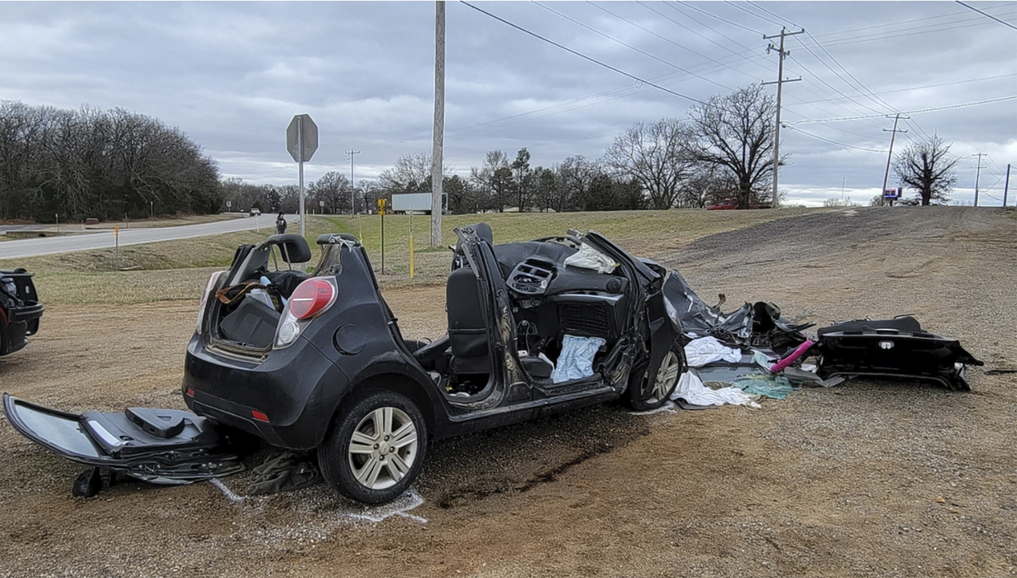 FILE - In this image provided by KFOR-TV, a heavily damaged vehicle is seen off a road in Tishoming...