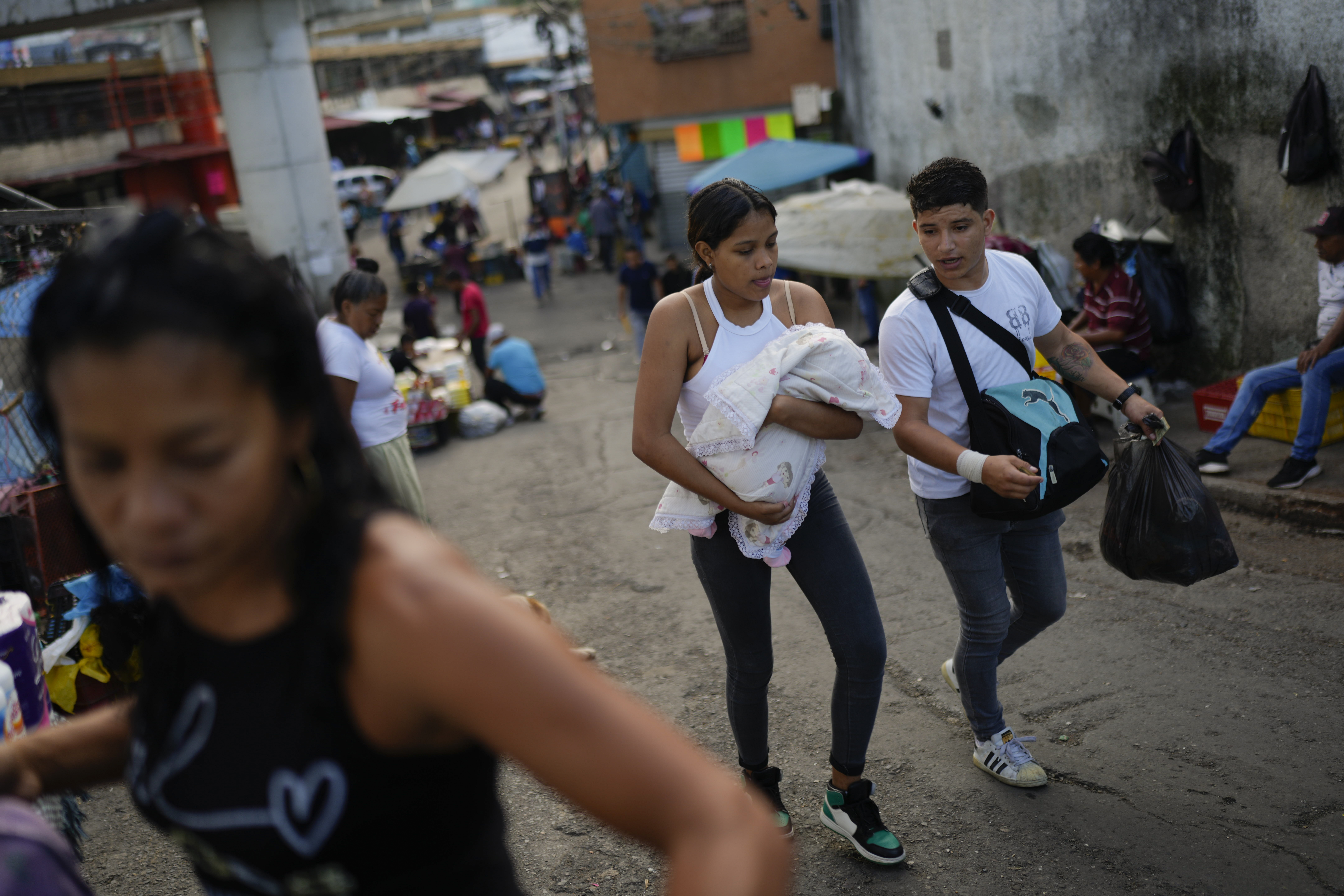Residents walk through the Petare neighborhood of Caracas, Venezuela, Tuesday, July 16, 2024. (AP P...
