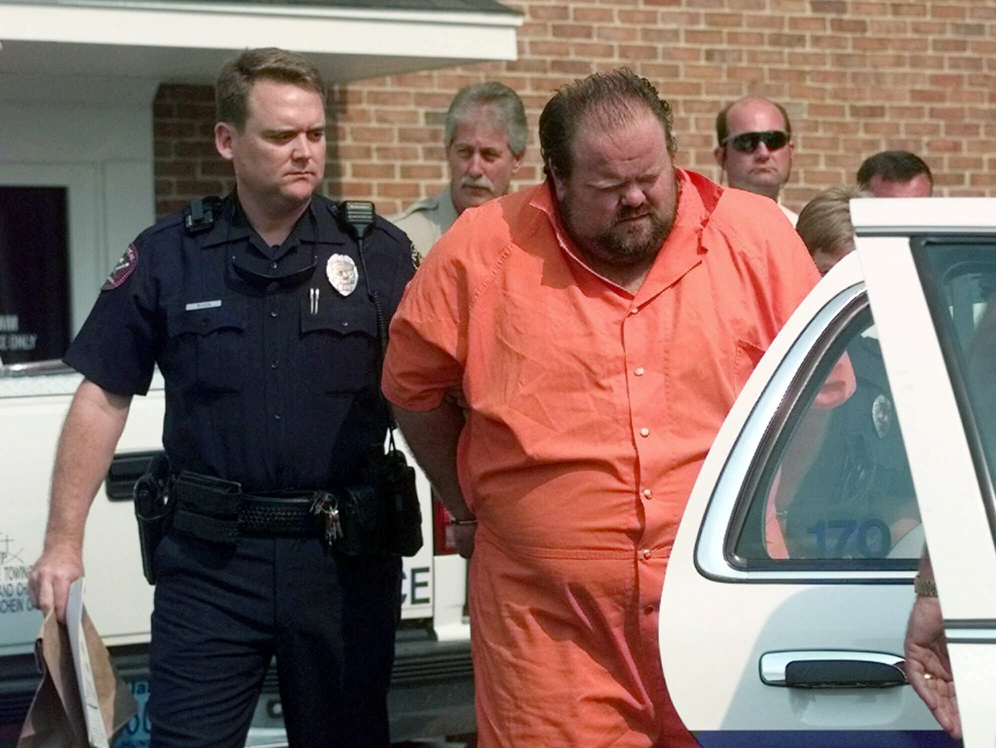 FILE - Officials escort murder suspect Alan Eugene Miller away from the Pelham City Jail in Alabama...