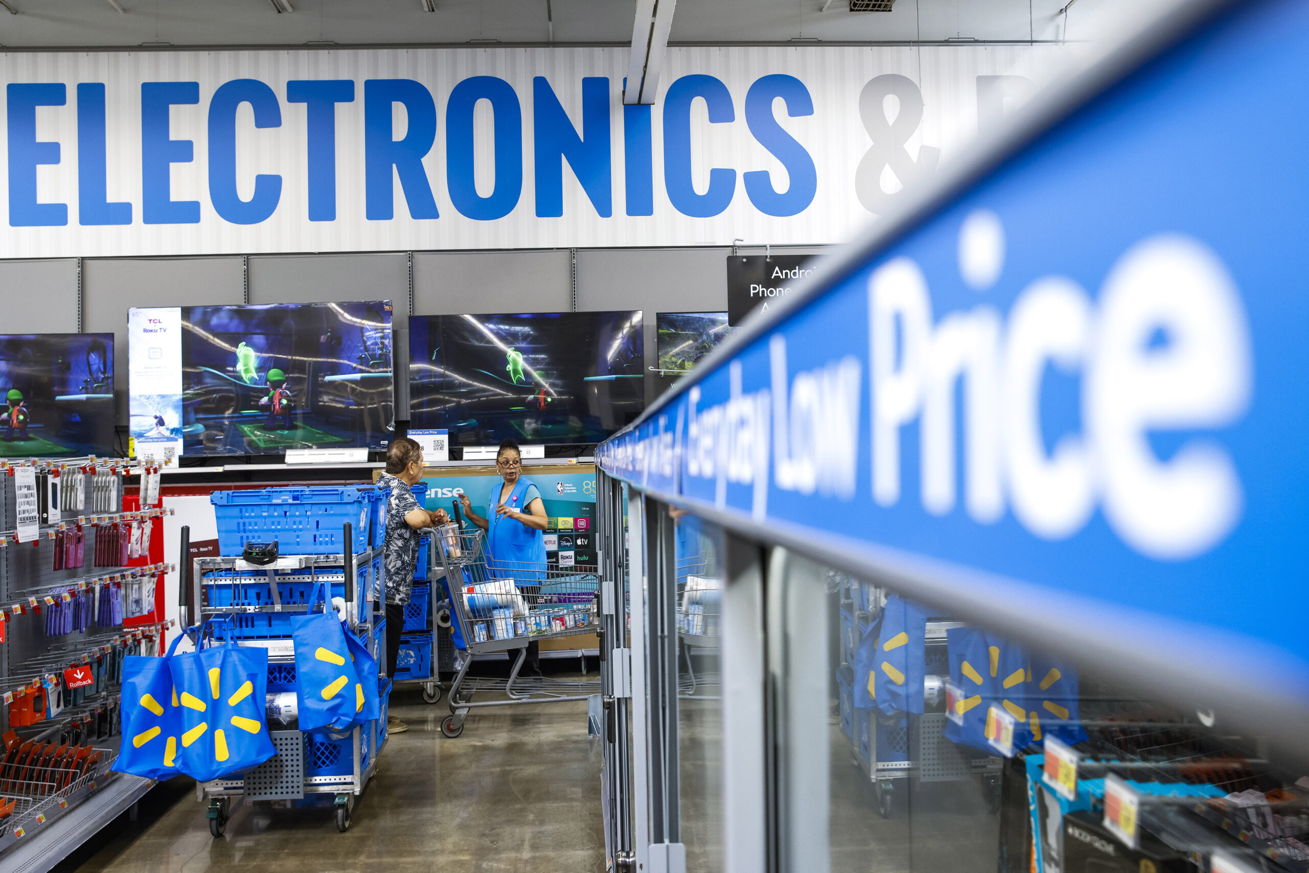 FILE - People walk around a Walmart Superstore in Secaucus, New Jersey, on July 11, 2024. (AP Photo...