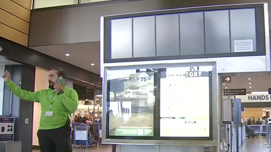 Image: At the top of this image, the reader board at Sea-Tac Airport that would normally have infor...