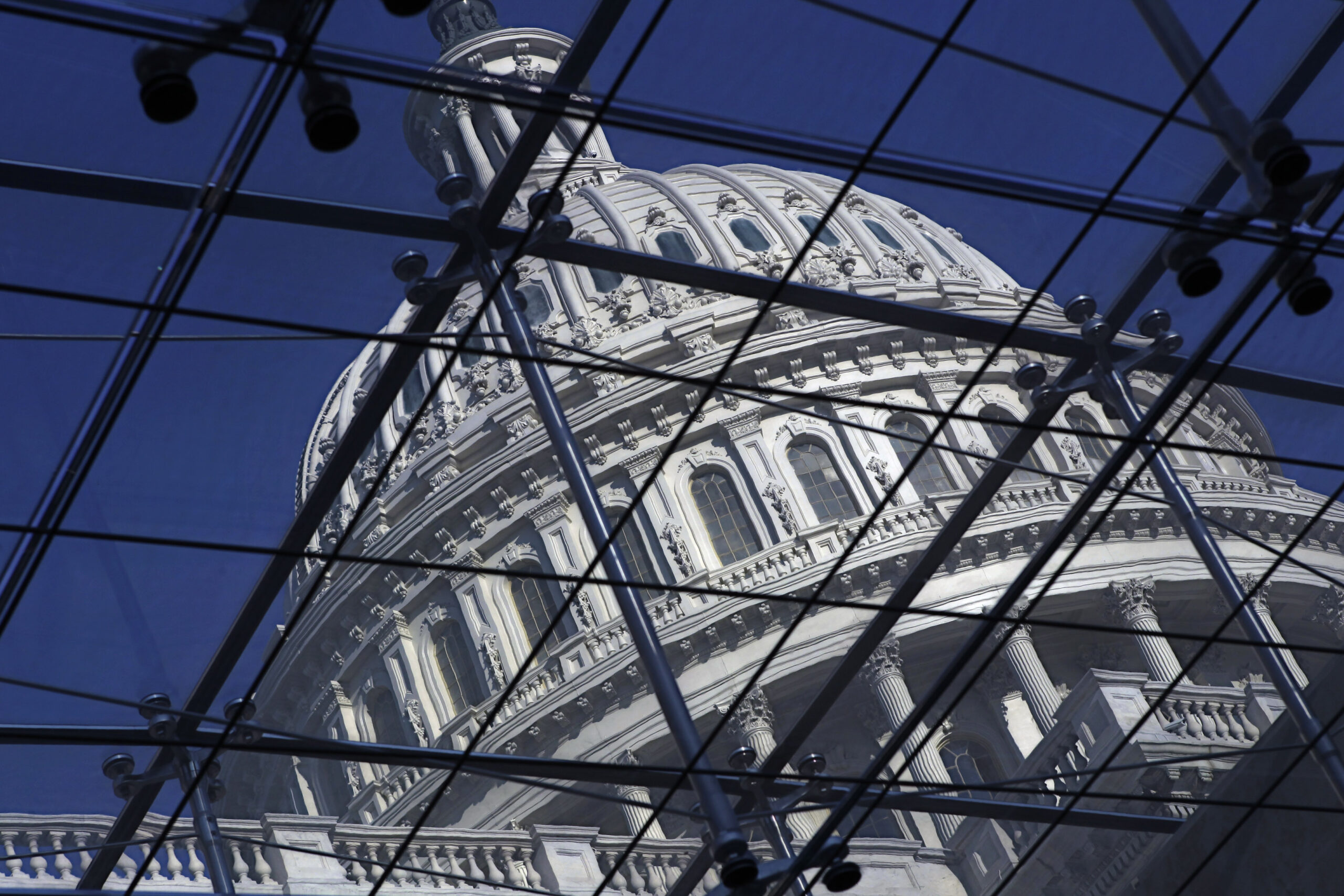 FILE - The Capitol dome on Capitol Hill is seen through a glass structure in Washington, on April 6...