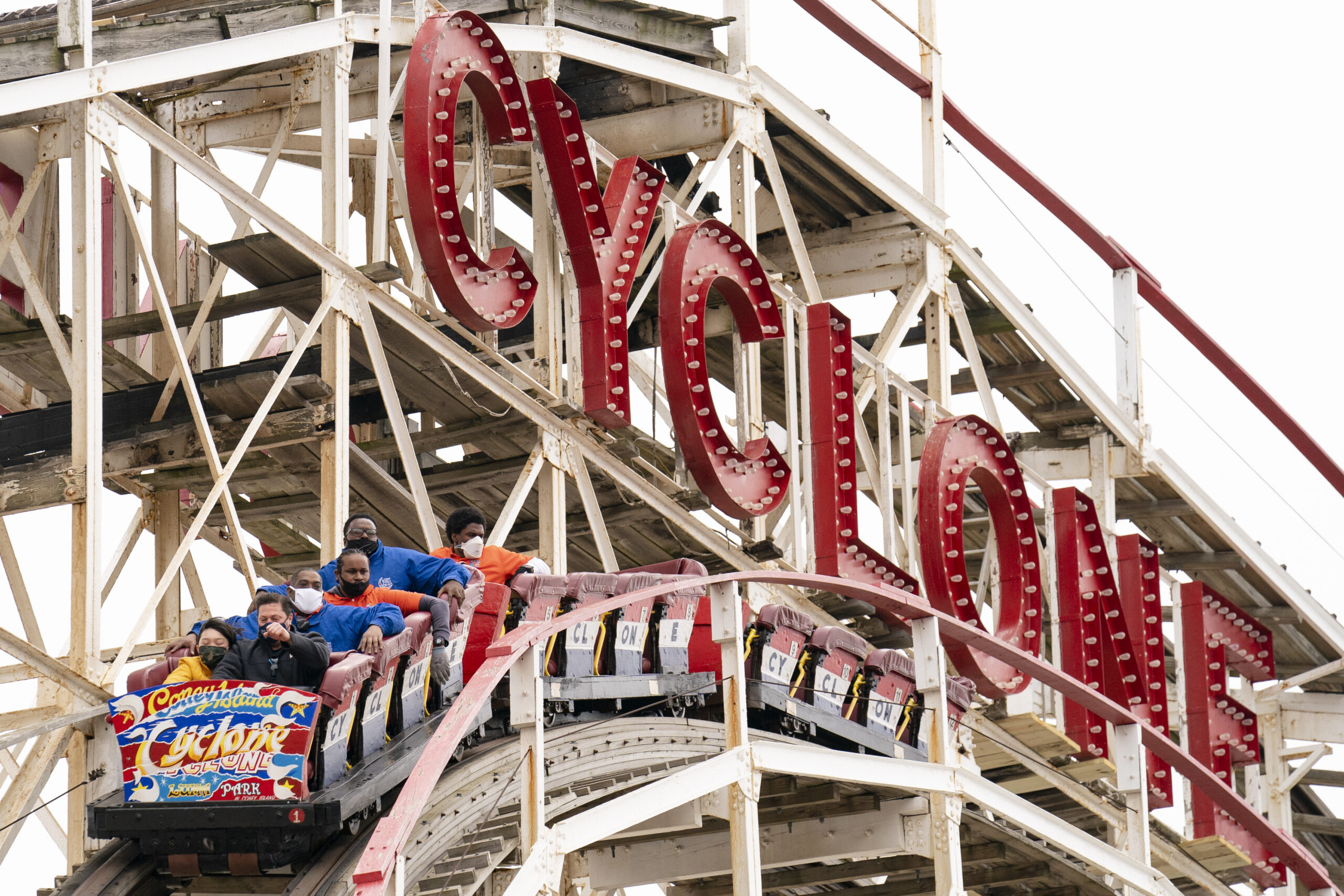 FILE - People ride the Coney Island Cyclone roller coaster, April 9, 2021, in the Brooklyn borough ...