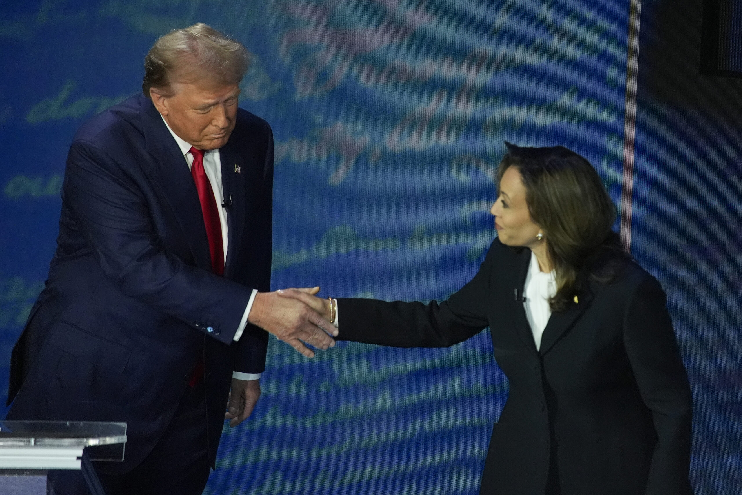 Republican presidential nominee former President Donald Trump shakes hands with Democratic presiden...