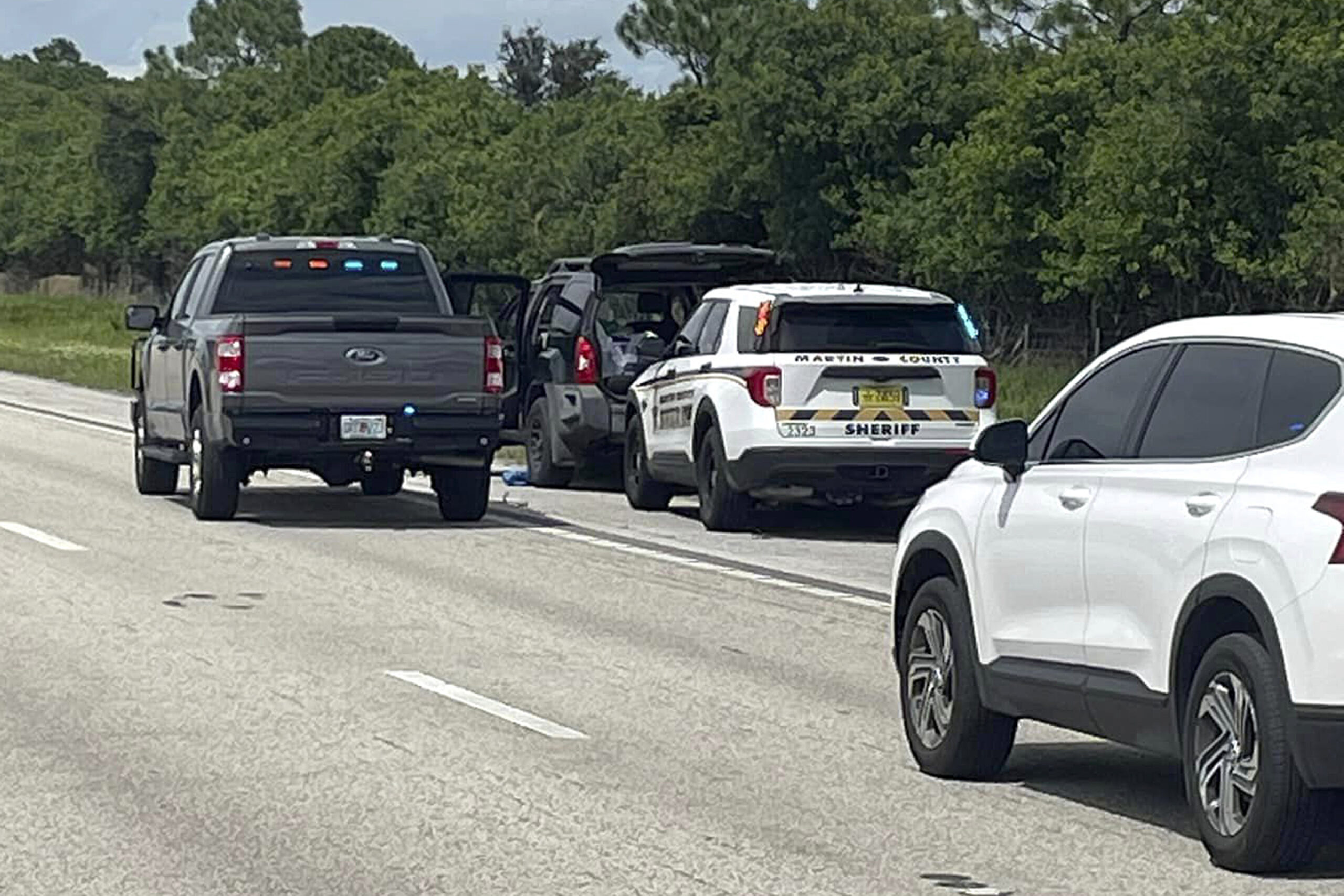 This photo provided by the Martin County Sheriff's Office shows Sheriff's vehicles surrounding an S...