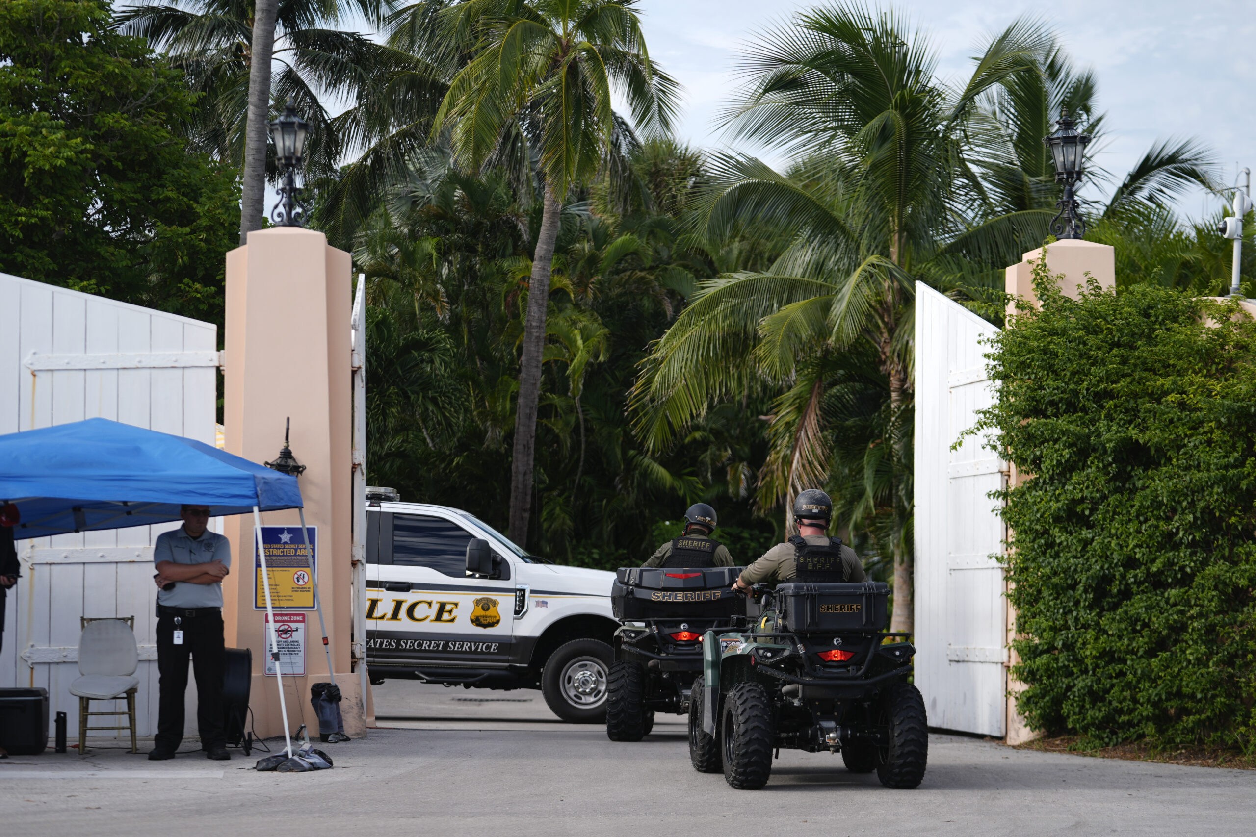 Police drive in to the Mar-a-Lago estate of Republican presidential nominee and former President Do...