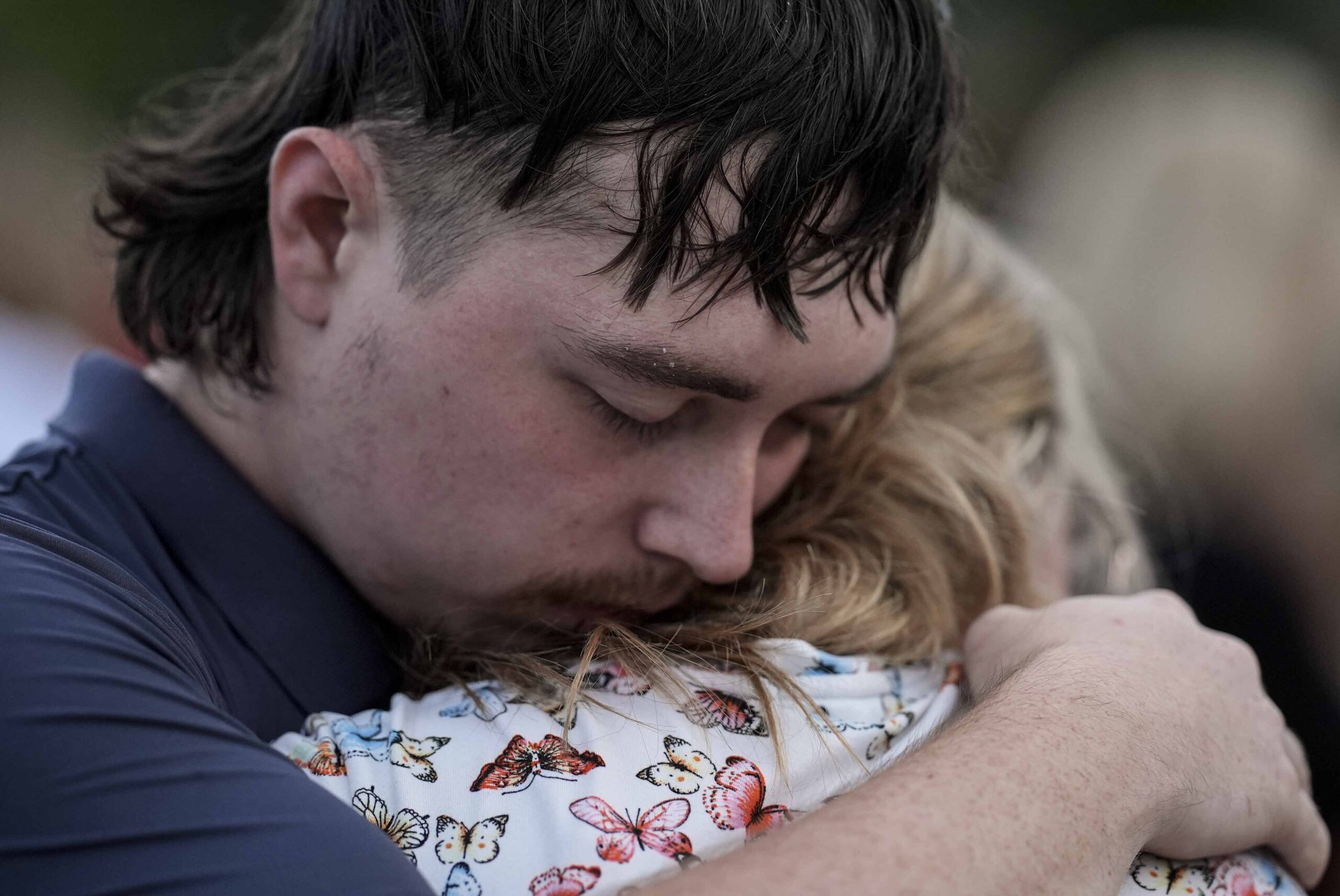 Mourners pray during a candlelight vigil for the slain students and teachers at Apalachee High Scho...