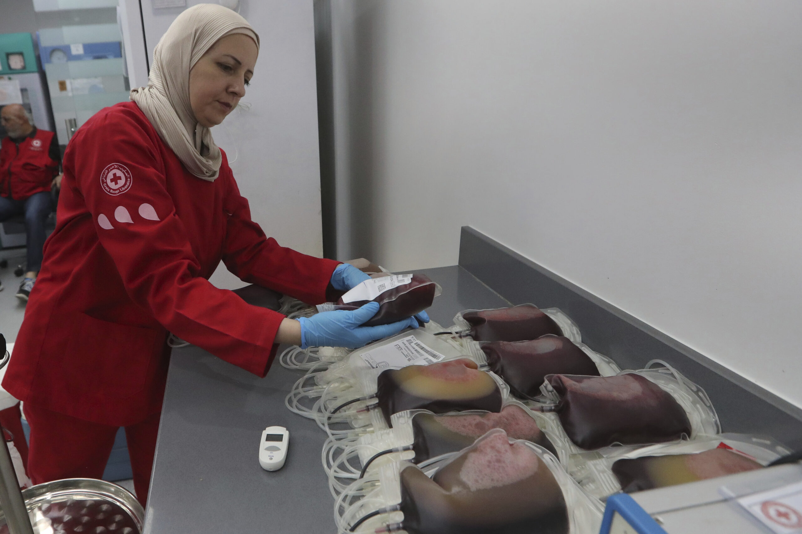 A Lebanese Red Cross volunteer collects blood donations for those who were injured by their explode...