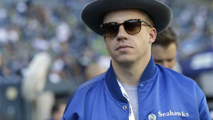 Photo: Rapper Macklemore stands on the sideline before a Seahawks game....