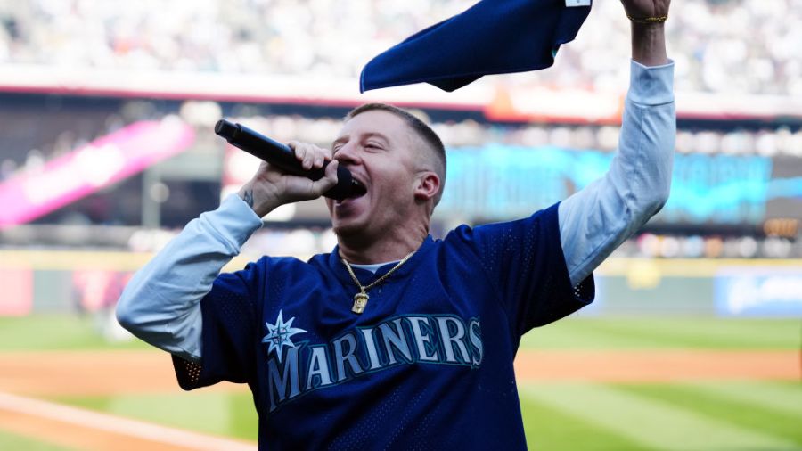 Photo: Rapper and Seattle native Macklemore hypes up the crows prior to the game between the Housto...