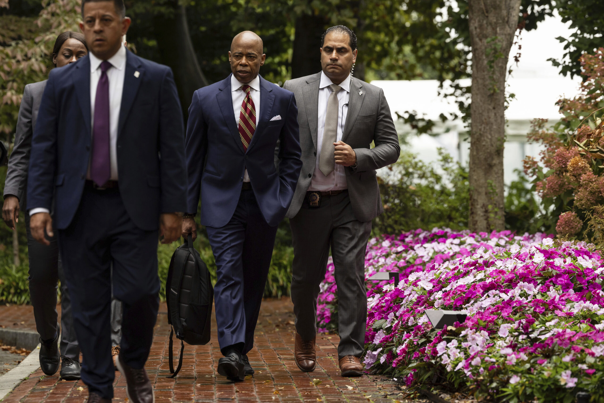 New York City Mayor Eric Adams, second right, exits Gracie Mansion, the official residence of the m...