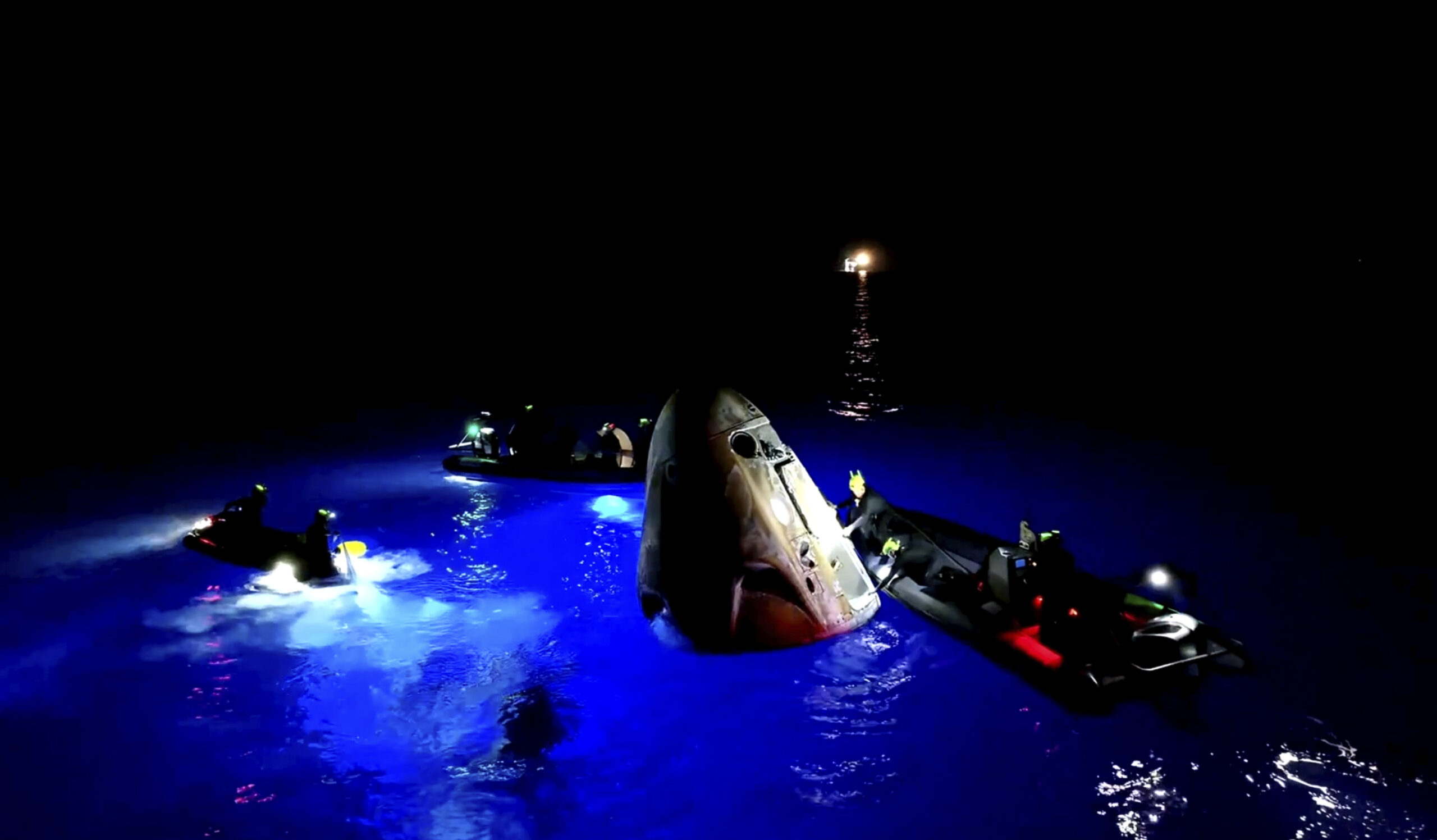 This image made from SpaceX video shows its capsule, center, carrying tech entrepreneur Jared Isaac...