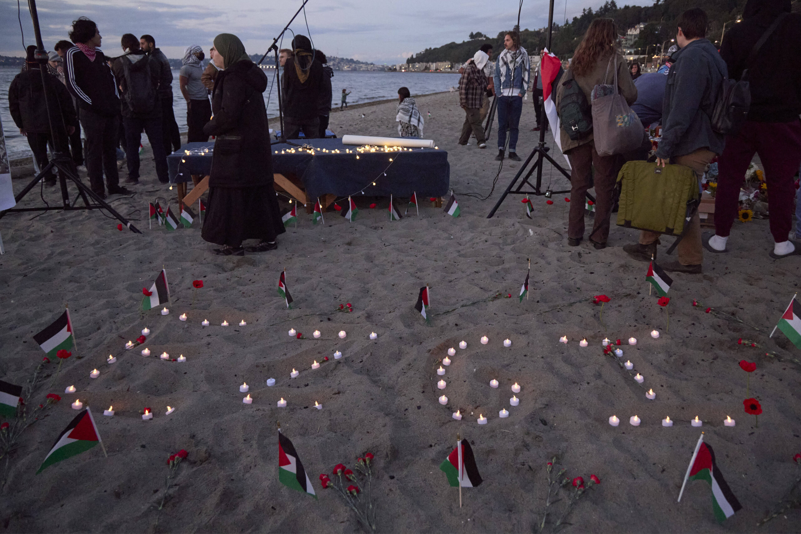 Ezgi is spelled in candles on the sand during a vigil on Alki Beach for Aysenur Ezgi Eygi, a 26-yea...