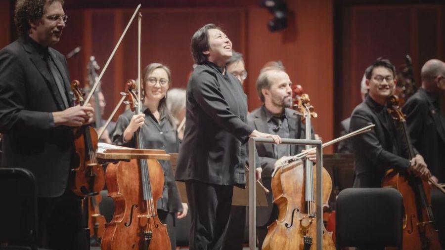 This image released by the Seattle Symphony Orchestra shows Xian Zhang, center, during a pre-concer...