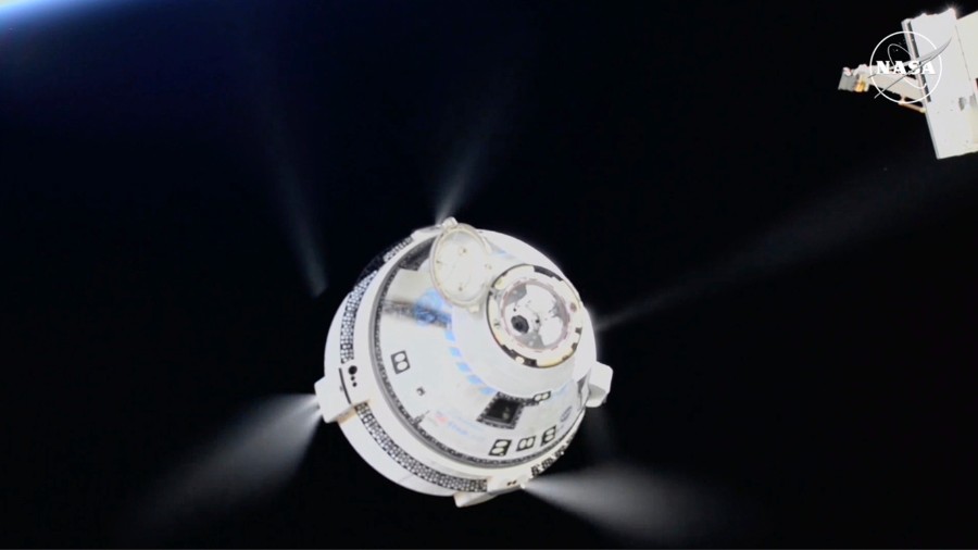 Image: In this image from video provided by NASA, the unmanned Boeing Starliner capsule fires its t...