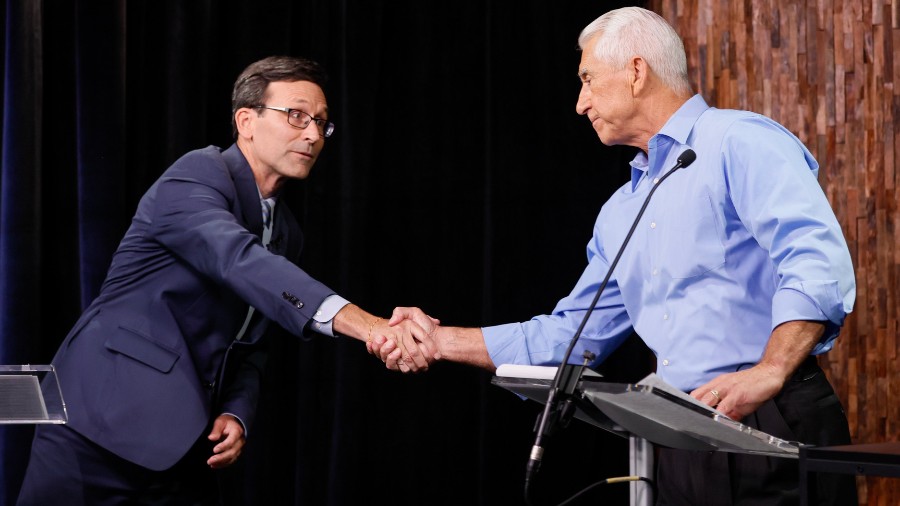 Image: Democrat Bob Ferguson, left, shakes hands with Republican Dave Reichert, right, during the W...