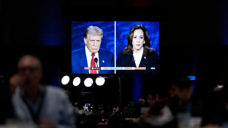 Image: Members of the press appear in the spin room during a presidential debate between Republican...