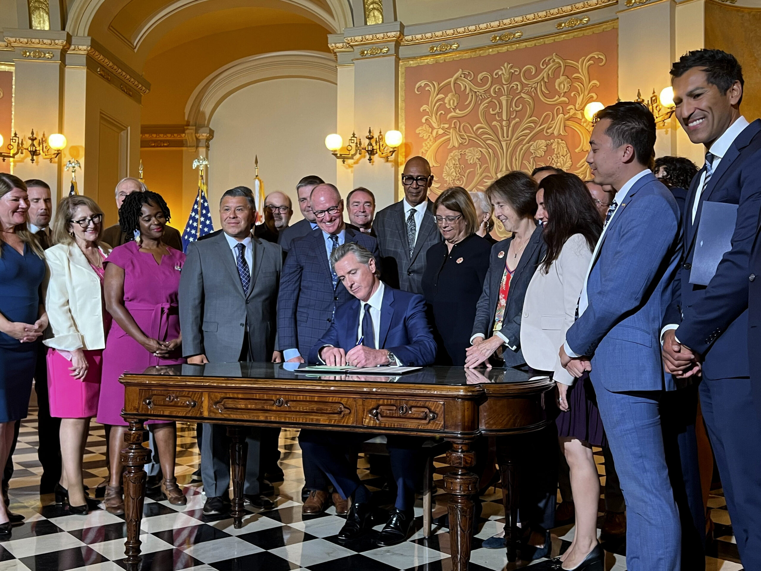 California Gov. Gavin Newsom signs legislation at the state Capitol on Monday, Oct. 14, 2024, aimed...