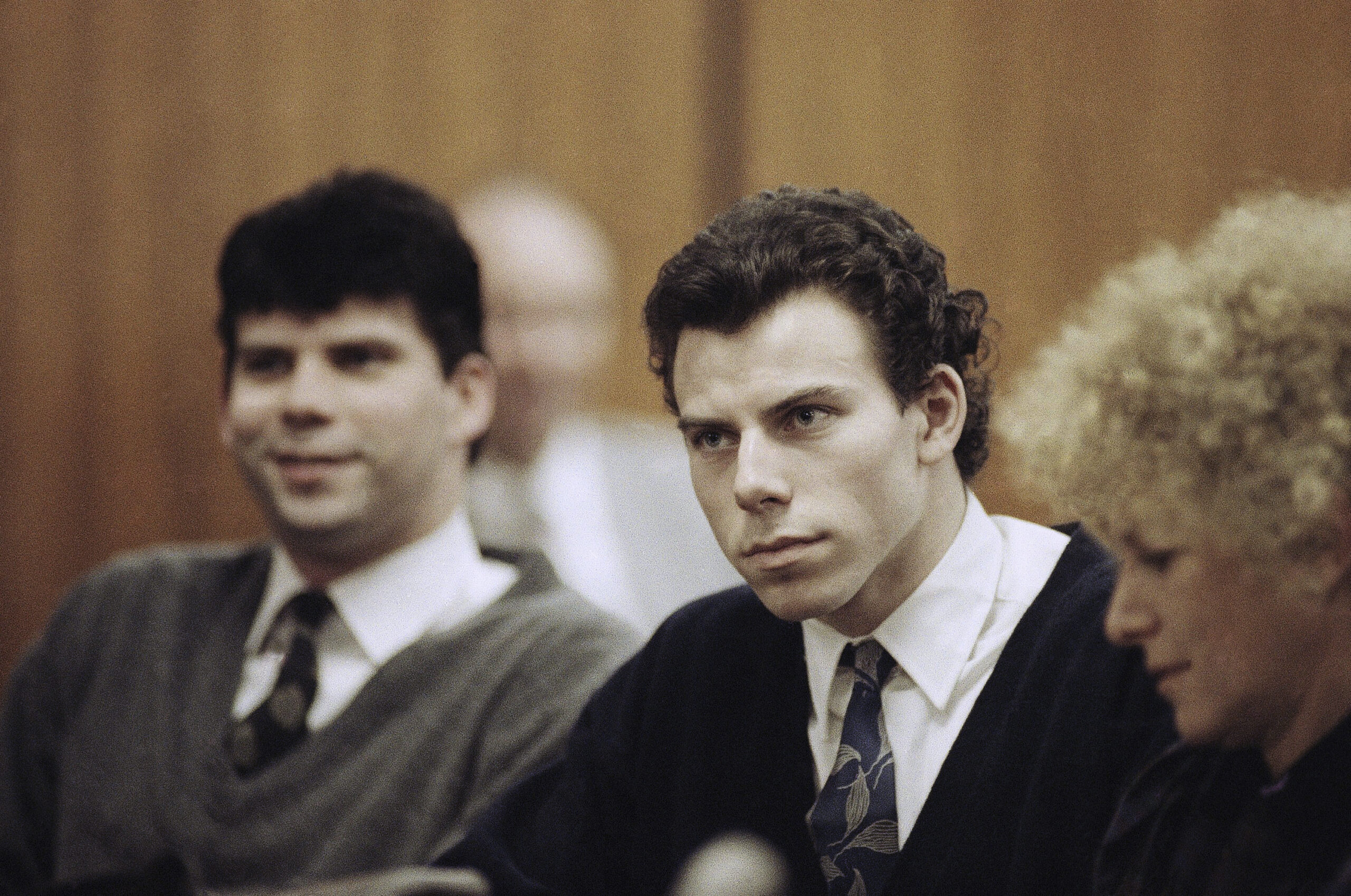 FILE - Lyle, left, and Erik Menendez sit with defense attorney Leslie Abramson, right, in Beverly H...