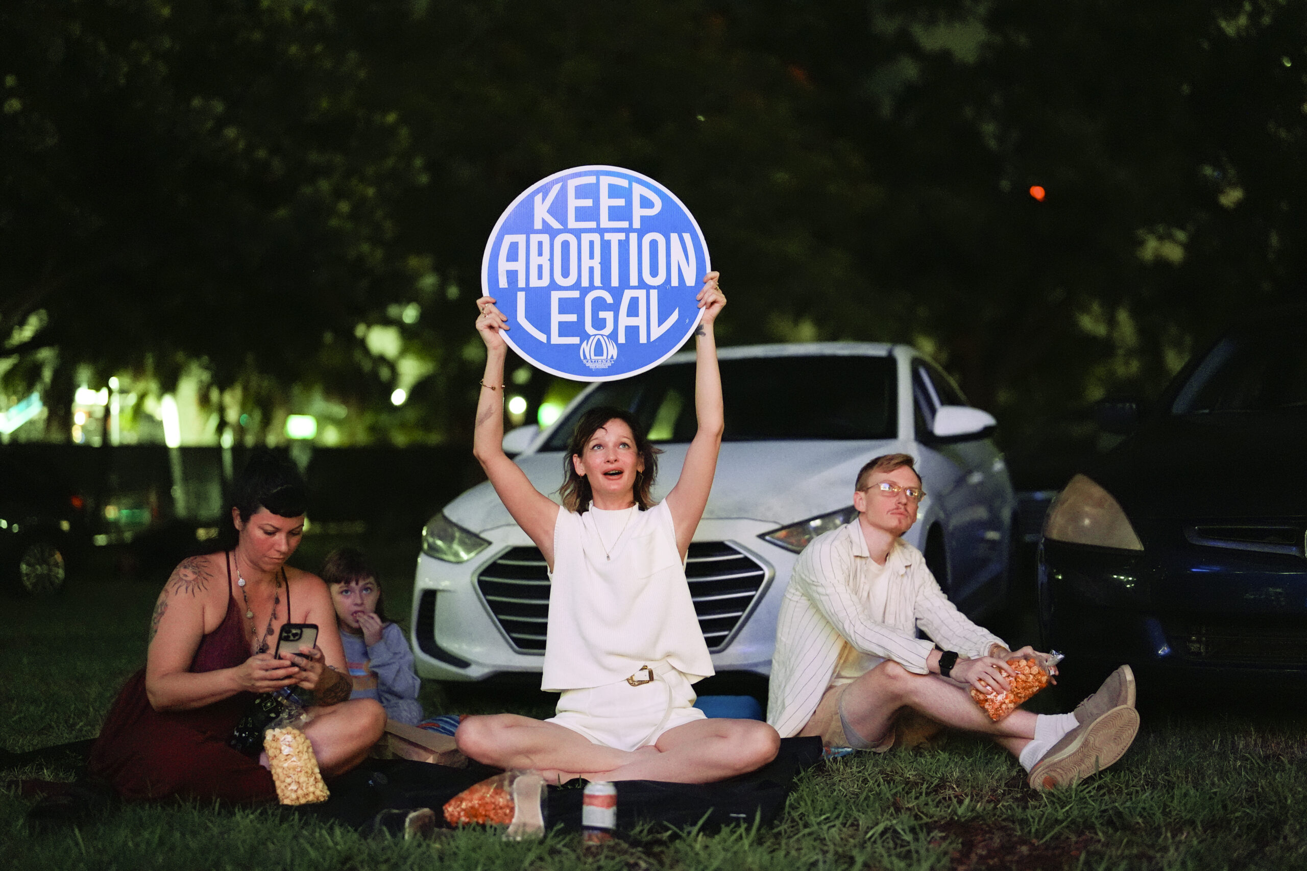 FILE - Reproductive rights advocate Kat Duesterhaus holds up a sign as U.S. President Joe Biden and...