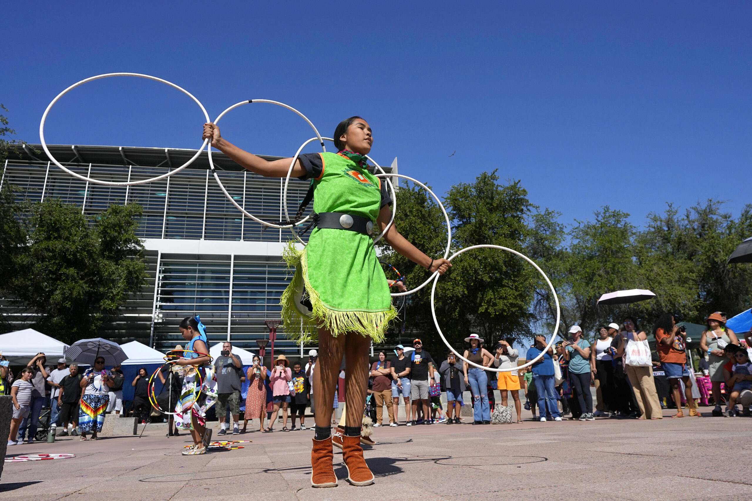 FILE - Performers from the Native American Hoop Dance of Ballet Arizona dance at an Indigenous Peop...