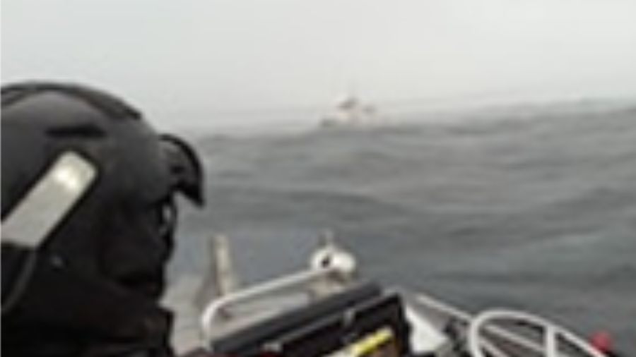 The Coast Guard rescued five crew members from a tugboat towing a 333-foot barge in rough seas off ...